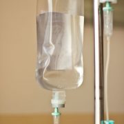 iv bag hanging on a metal pole in the room