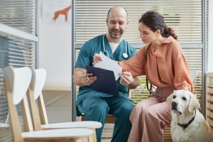 vet talking to dog owner