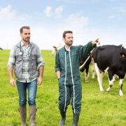 vet and farmer walking in a field